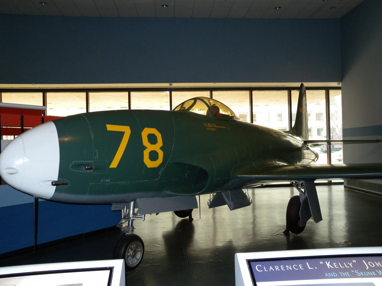 the fighter jet is green and yellow in color