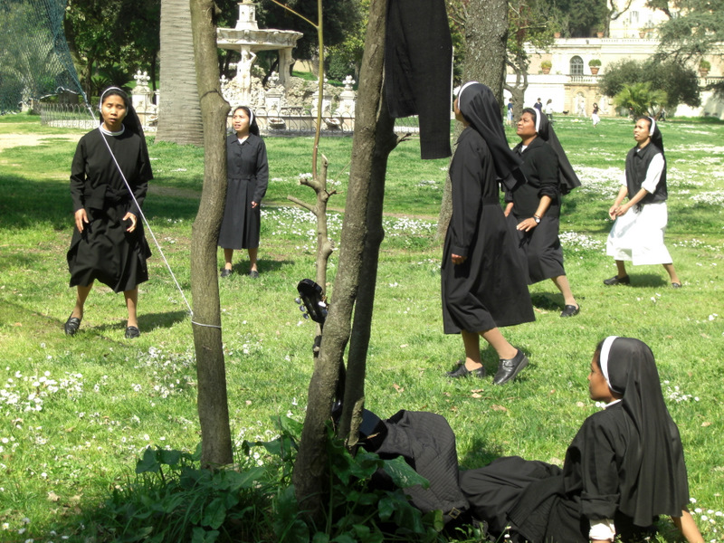 some women are dressed in black with veils on