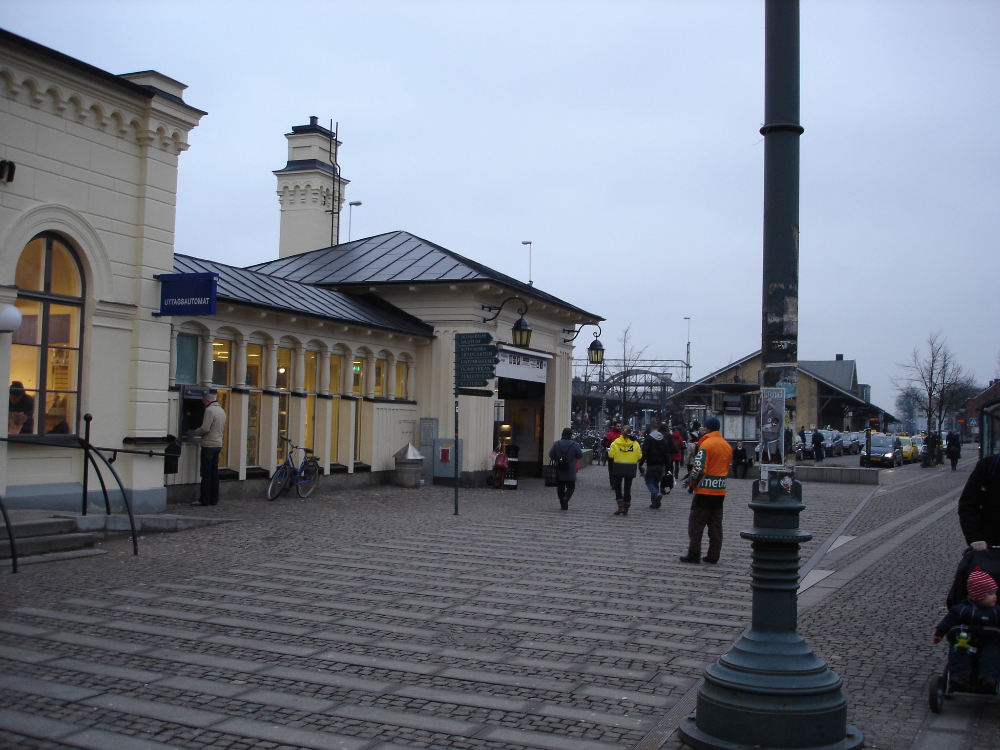 a small town with two people walking near the building