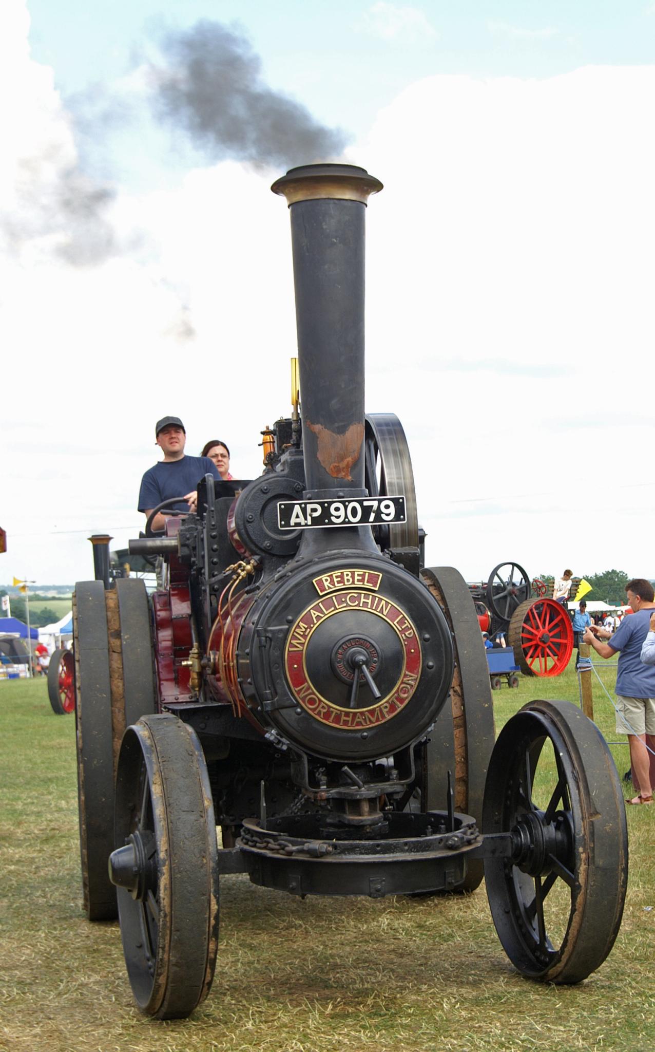 there is a steam engine on display and people are looking around