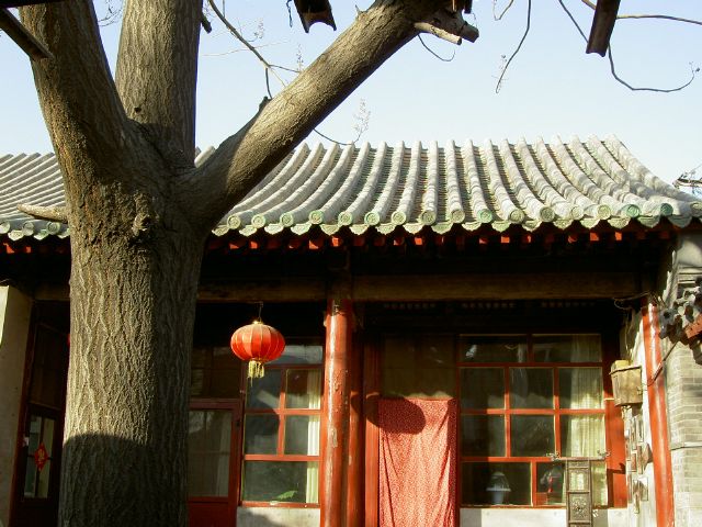 the orange lantern is hanging in front of a small building