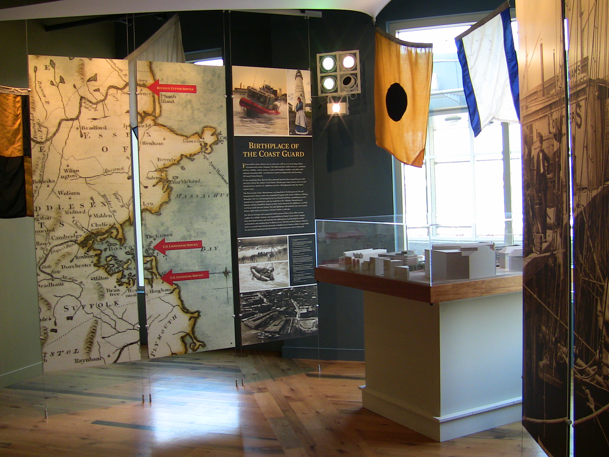 a view inside a museum, showing a few different colored maps