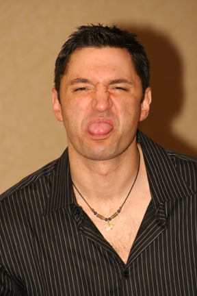 a man making a goofy face with his tongue out