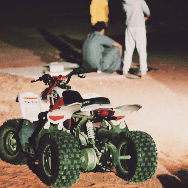 a small quad parked on top of some dirt