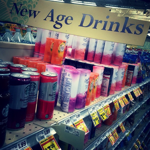 a shelf with new age drinks in a store