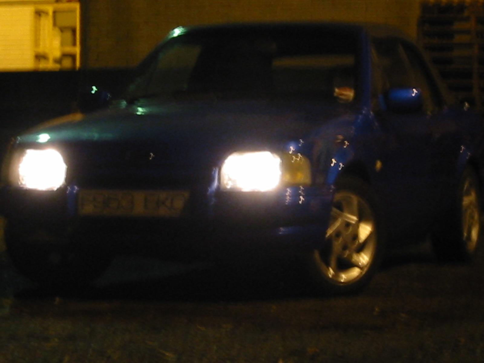 a close up view of a car with headlights on