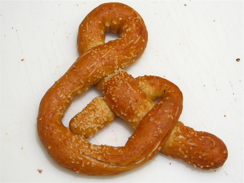 two pretzels, each shaped like a ring, are on a surface