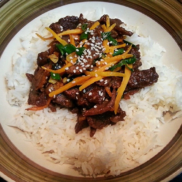 rice, beef and cheese on a white plate