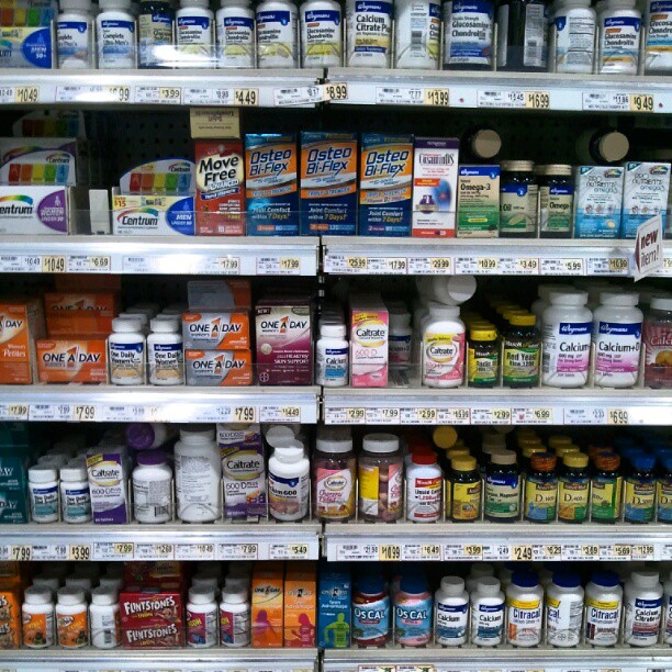 a shelf with many different colored pills