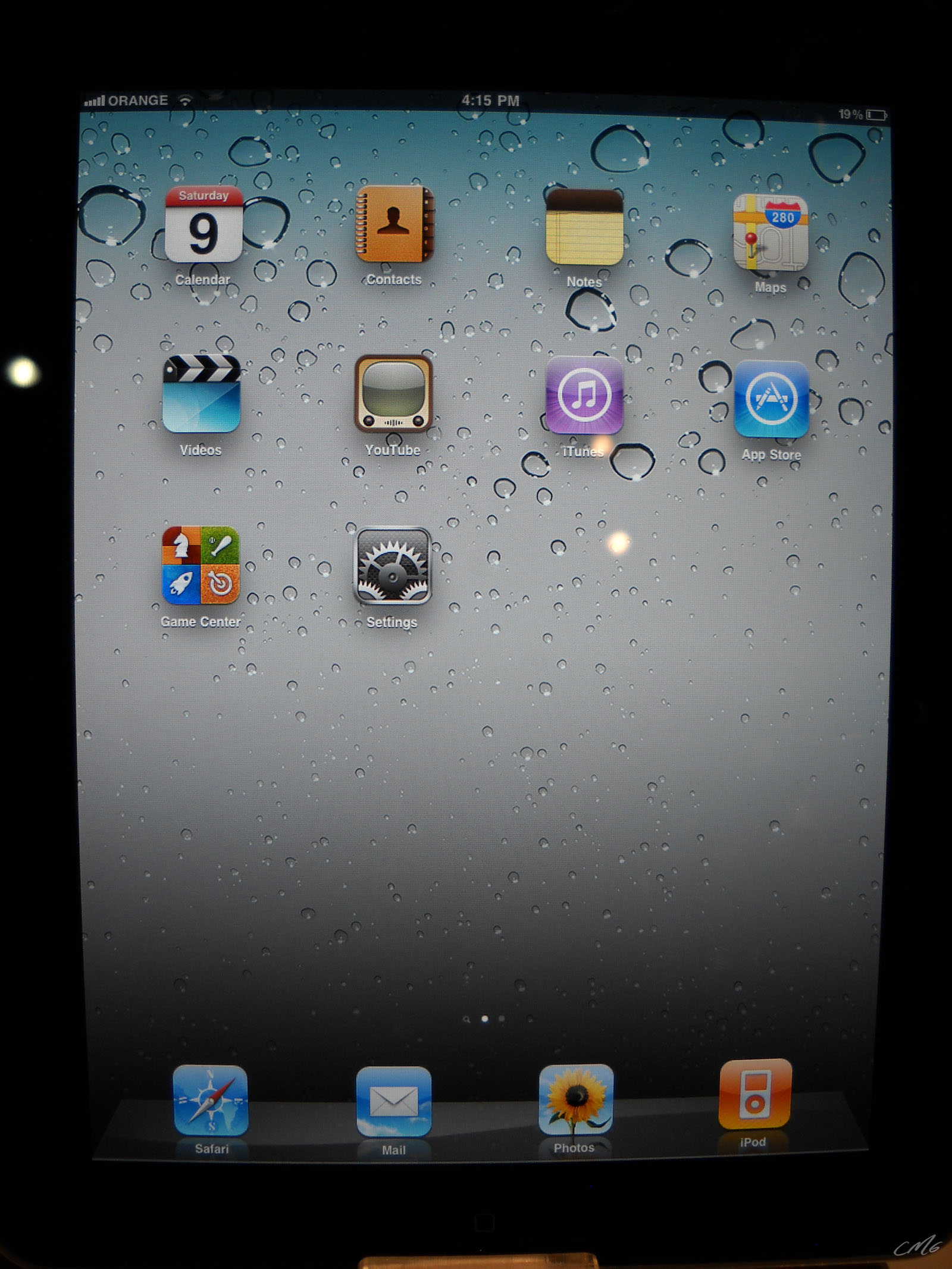 a cell phone and an ipad with water droplets on it