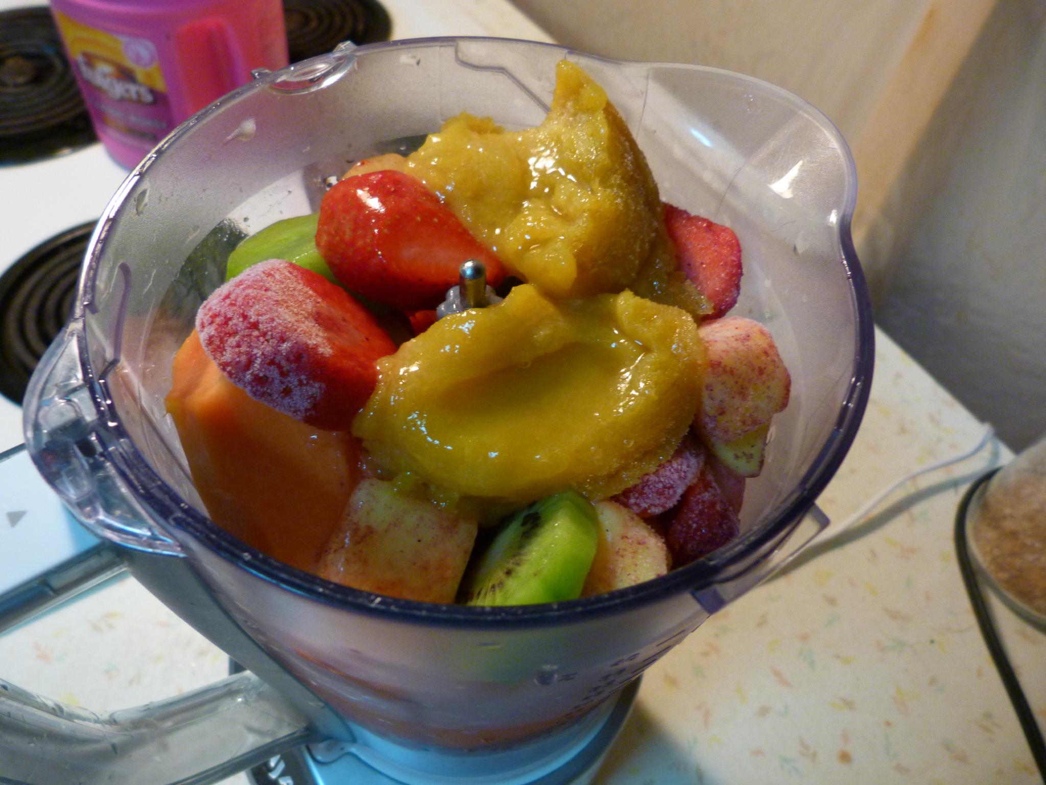 a plastic bowl filled with lots of fruit