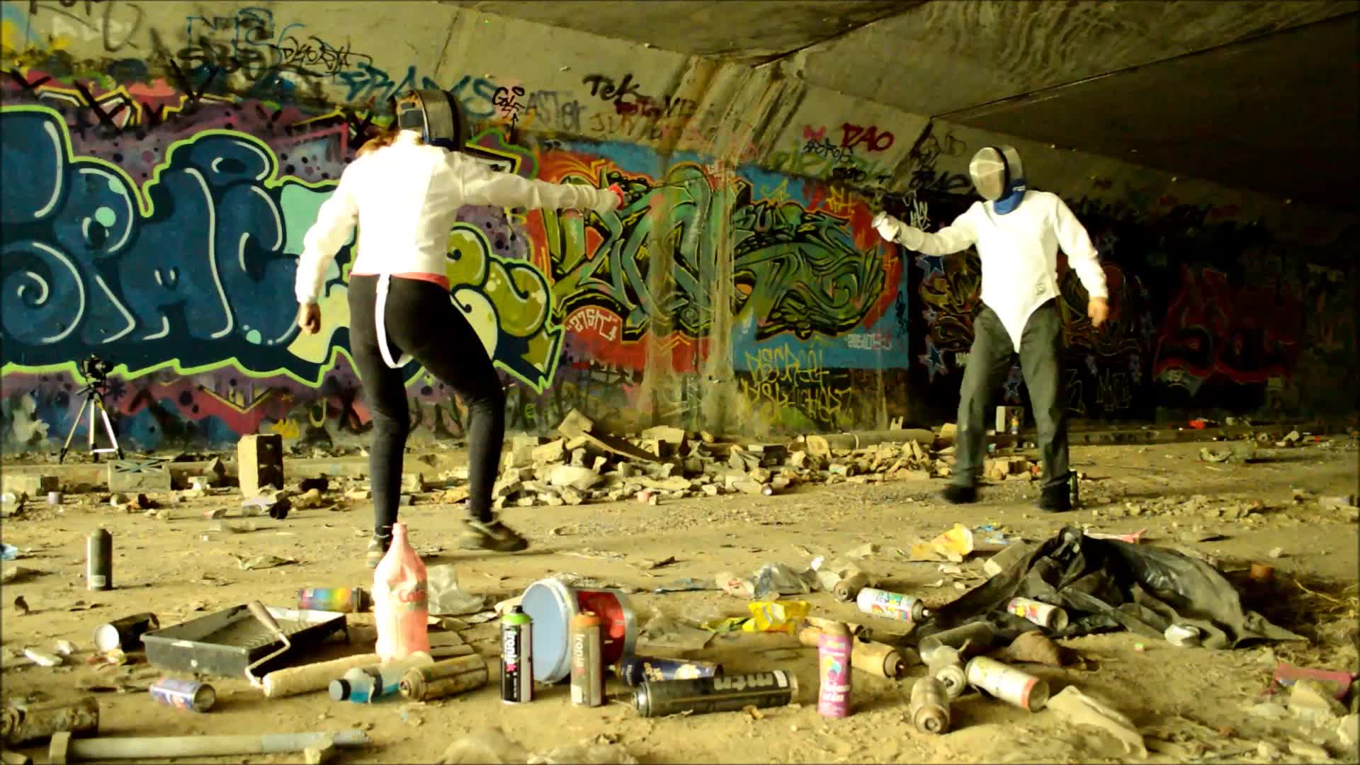 two men are playing with some toys in an abandoned building