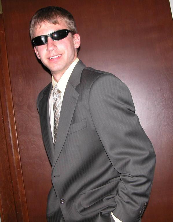 a man in a suit and sunglasses is posing for a po