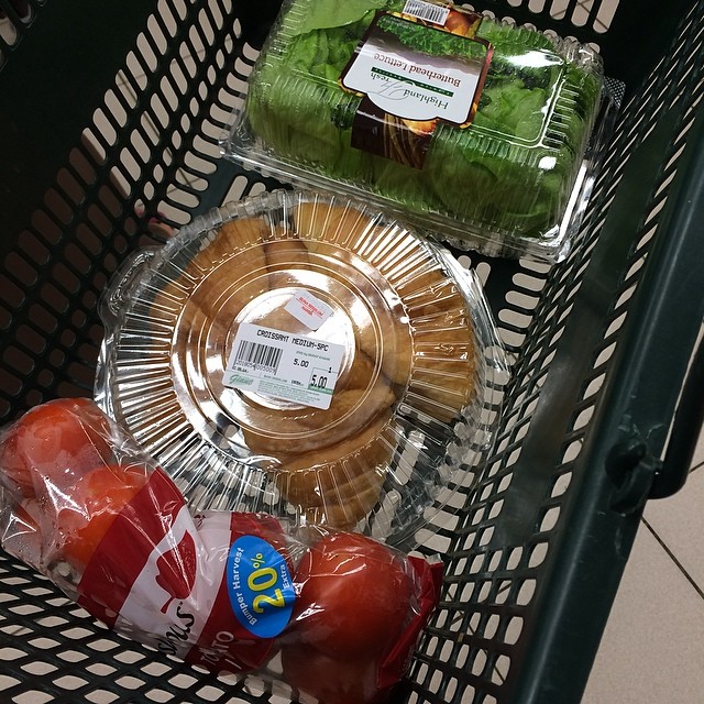 a shopping basket that is holding some food