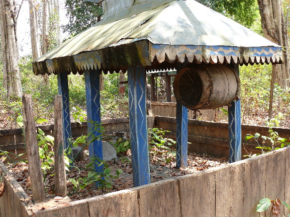a blue and white gazebo that is on top of a wooden fence