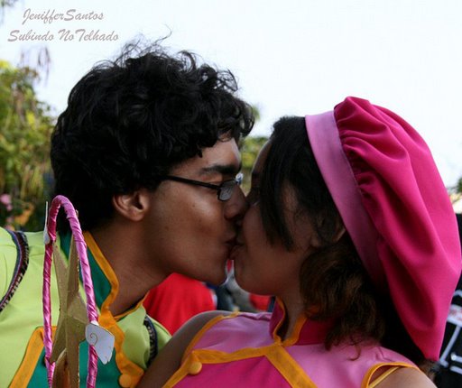 a man kisses a woman in a costume