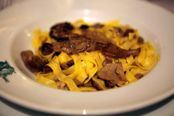 pasta with beef and cheese in a white plate