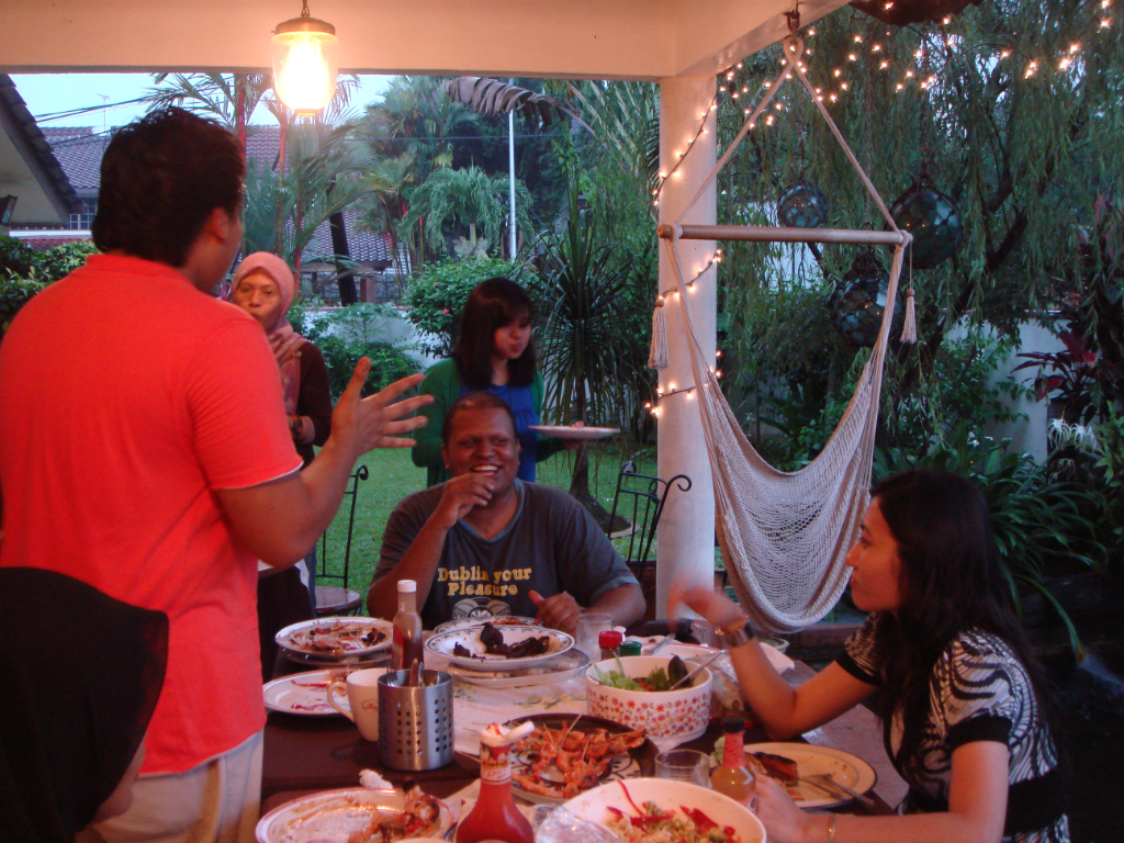 a group of people around a table talking