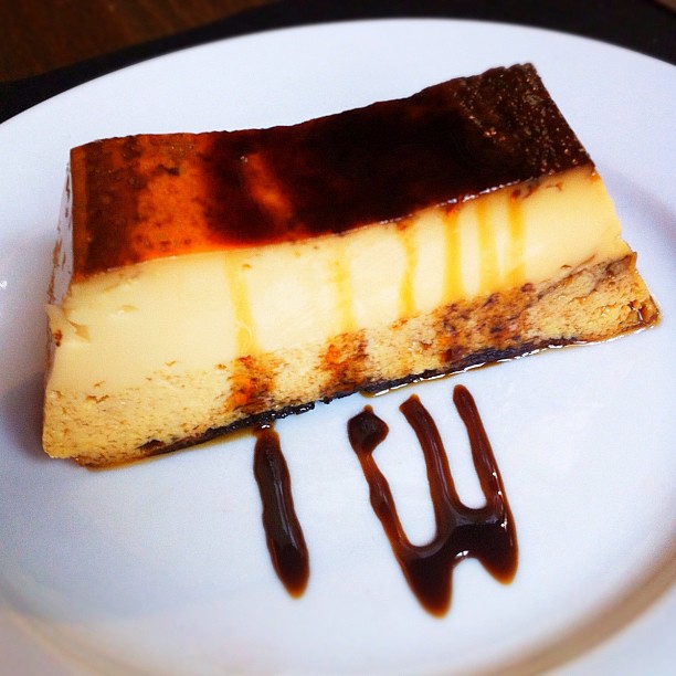 a piece of chocolate cheesecake sits on a white plate