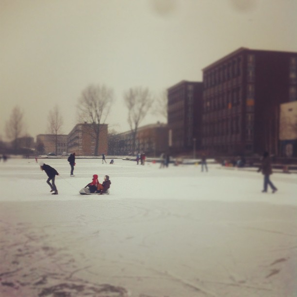 people on snow covered ground in urban setting