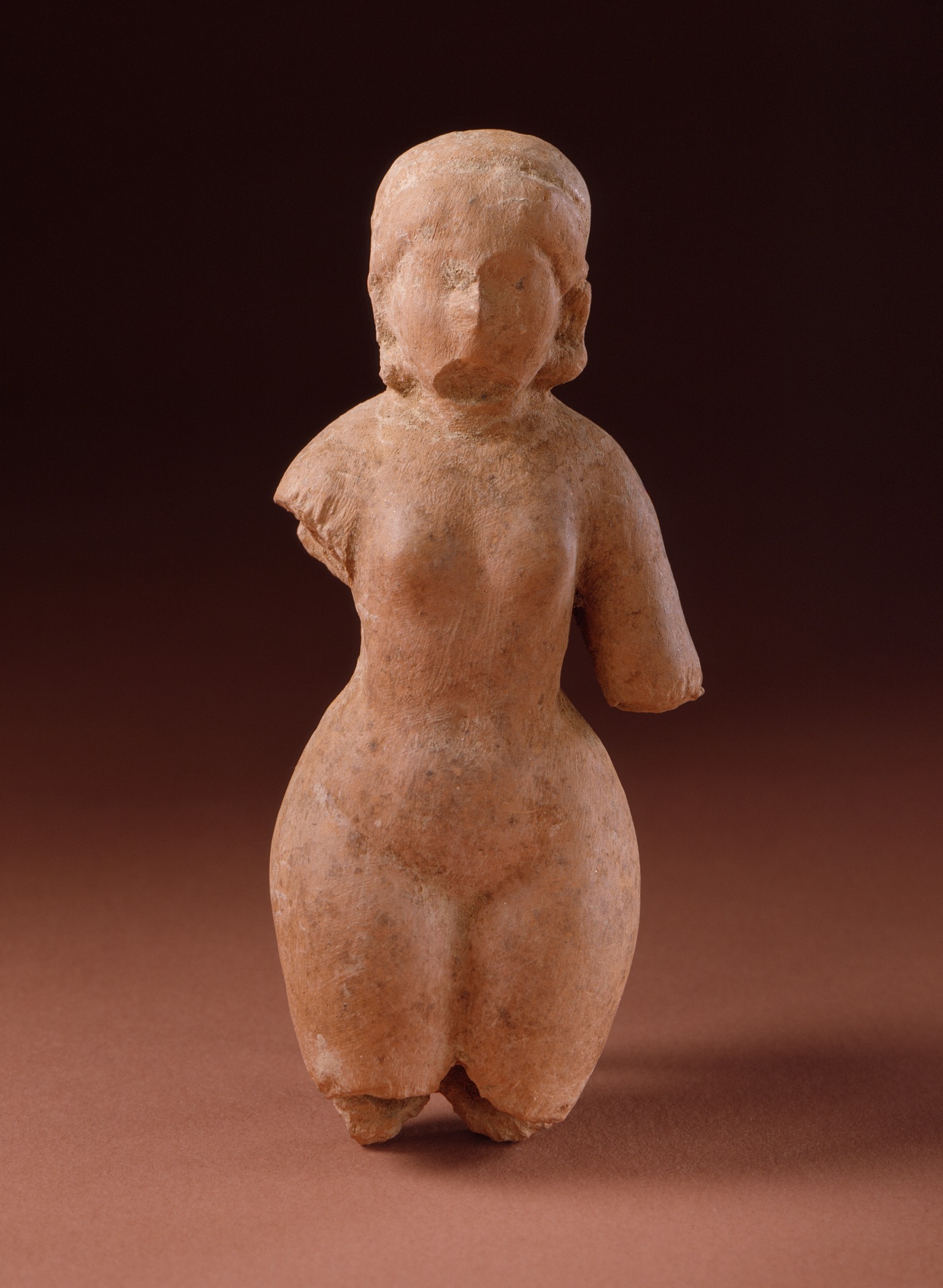 this ancient statue depicts a woman on a red ground