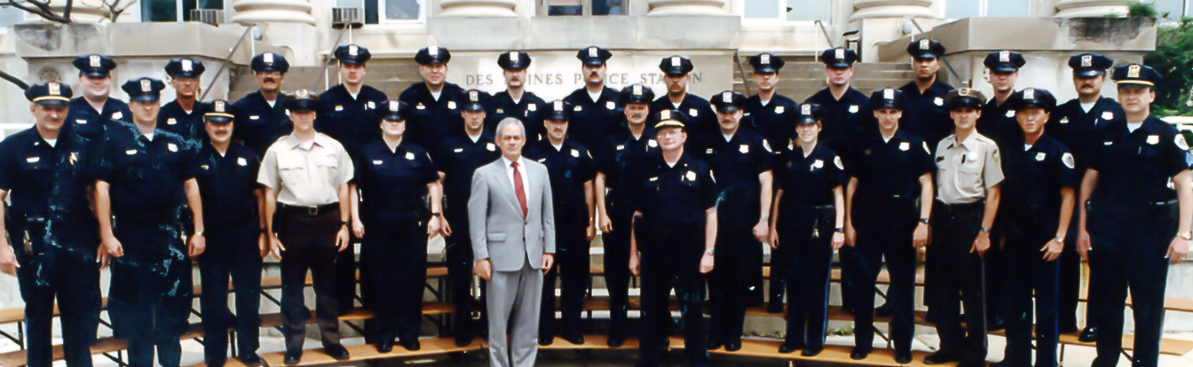 an officer standing behind a group of uniformed men