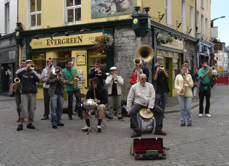people on a street playing music and singing