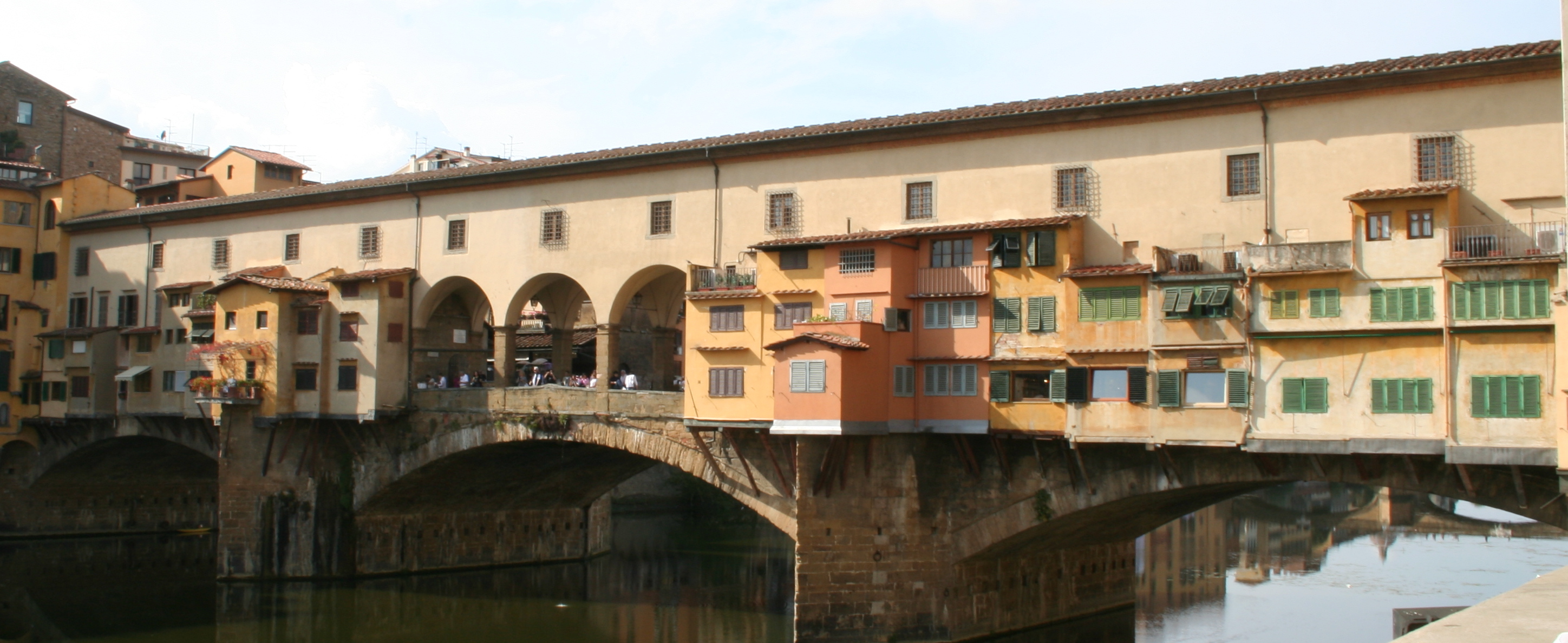 bridge with arch in middle over river in old town area