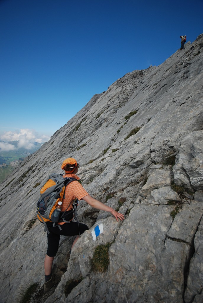 a man standing on top of a mountain near some rocks