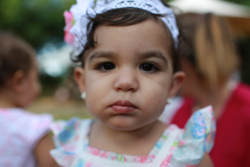 a little girl that is holding a cigarette