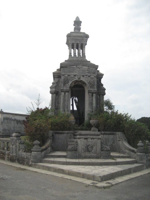 a stone structure with statues and stairs