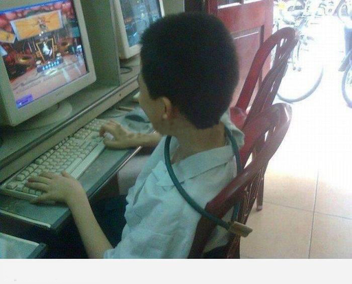 a young child is sitting at the computer