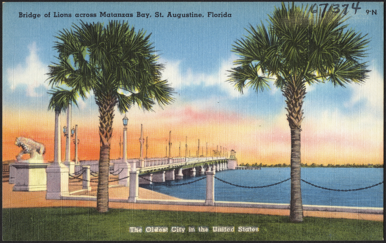 a postcard depicting the bridge between two palm trees