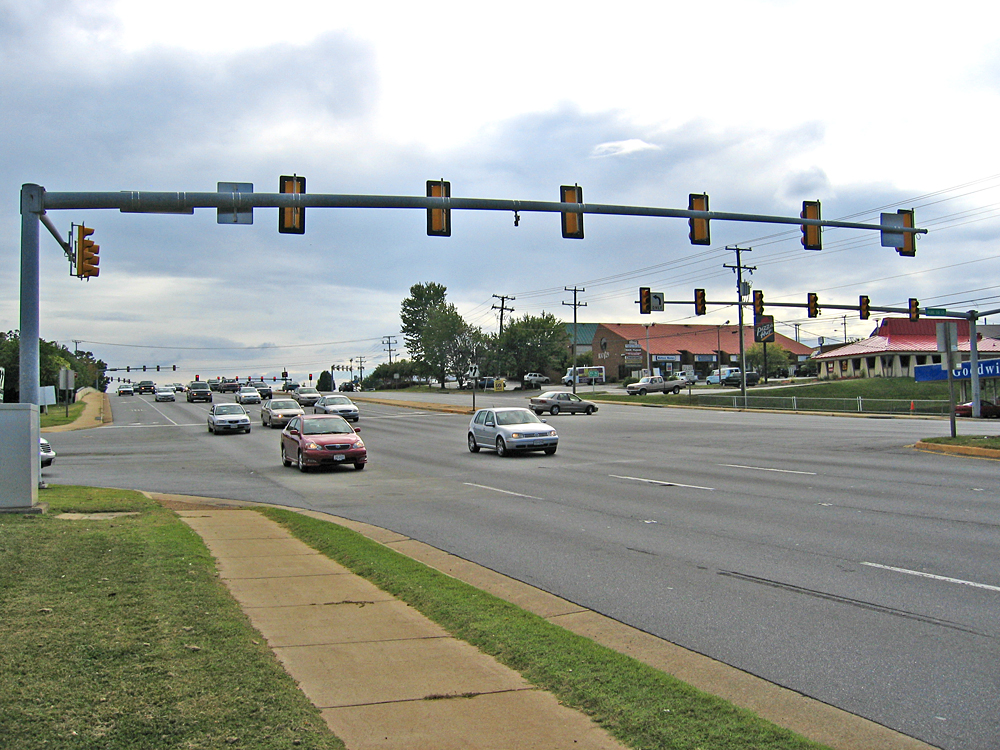 two lane intersection with traffic lights and cars on both sides