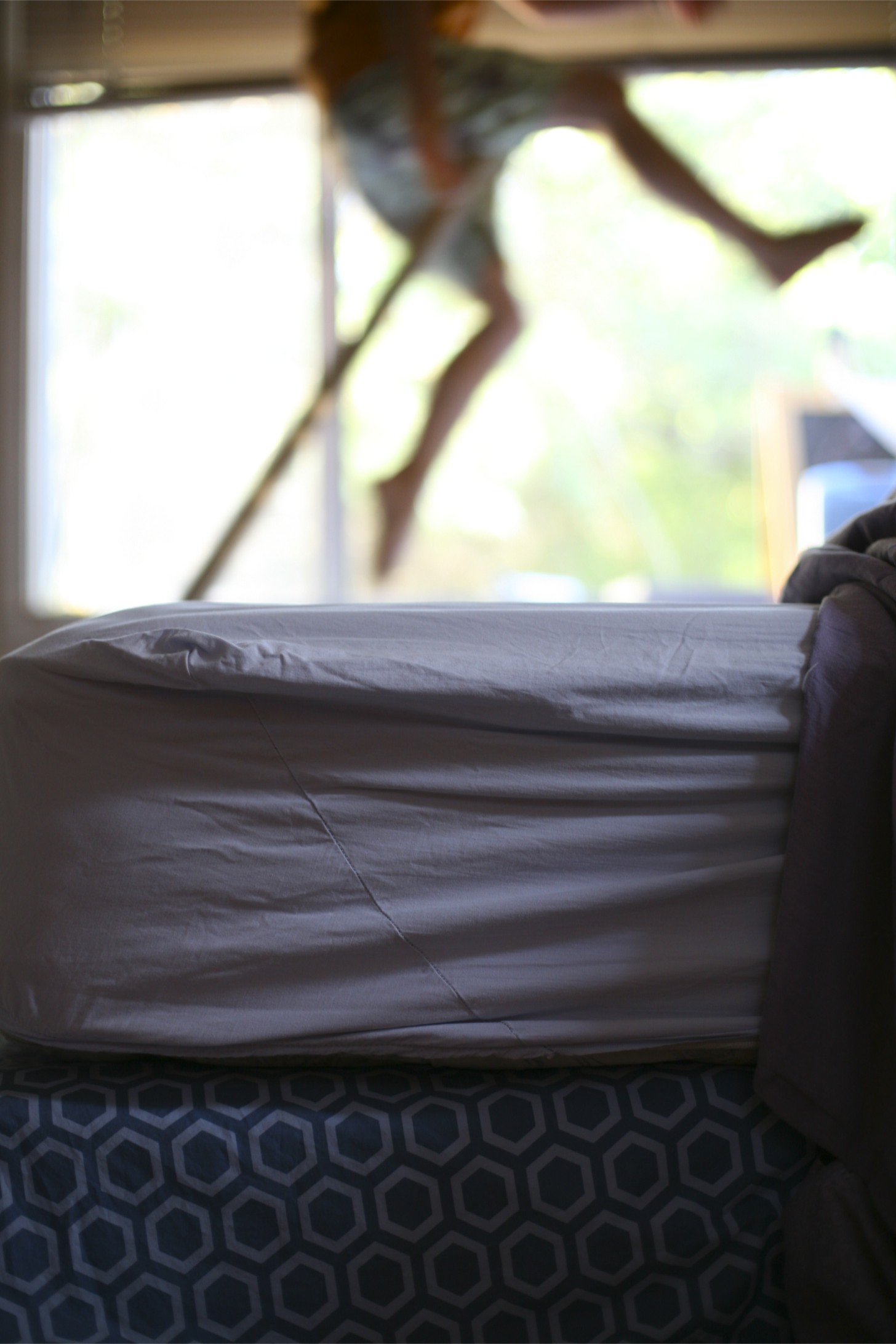 an image of a person walking across the air above bed