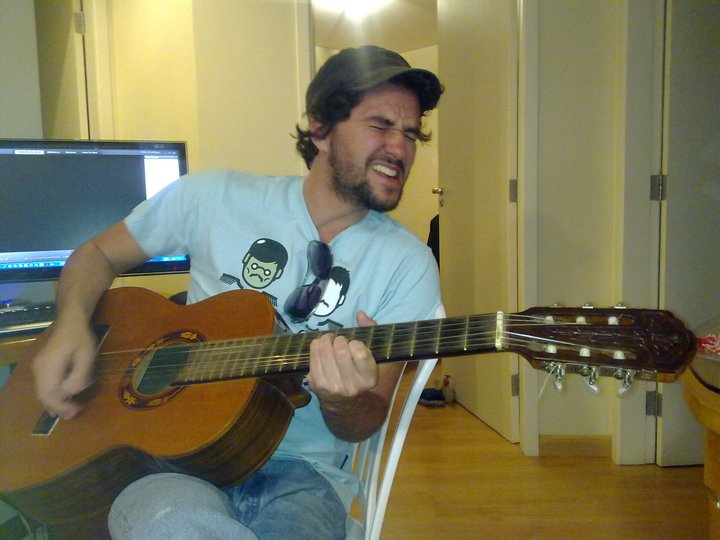 a man playing a guitar in his apartment