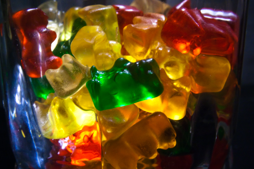 gummy bears are arranged in a clear vase