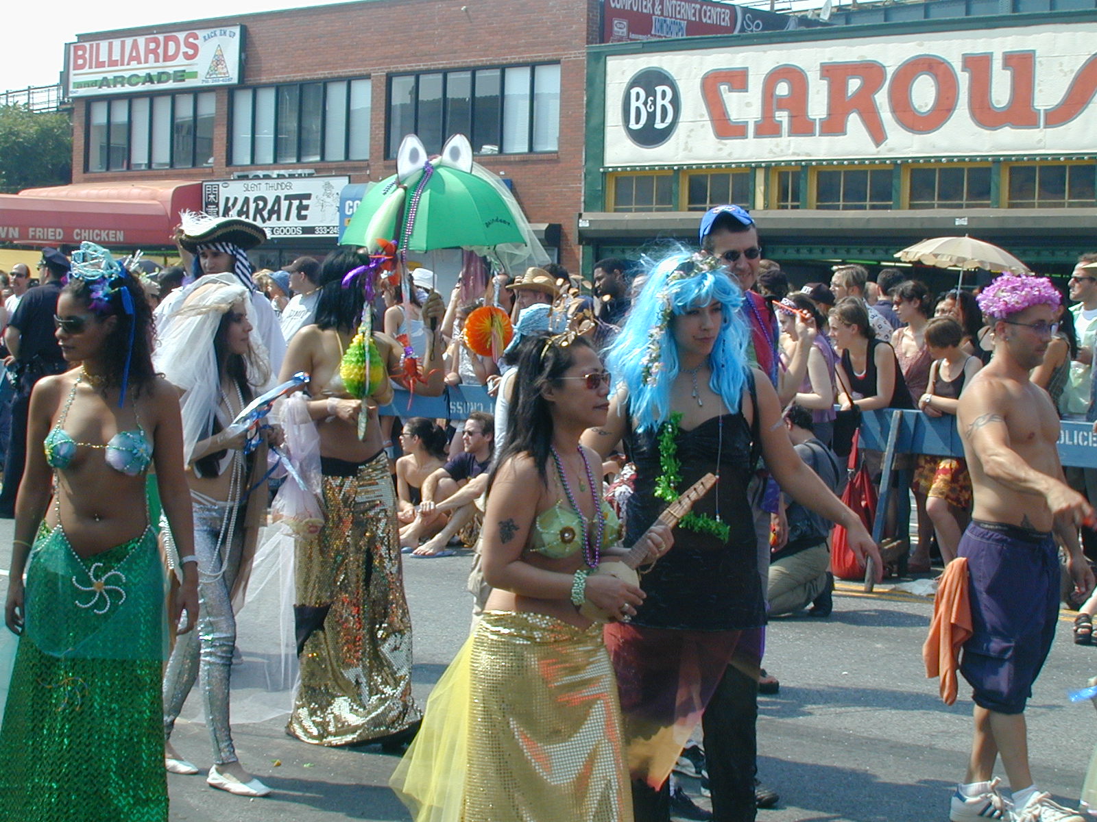 people in colorful costumes walk along the street