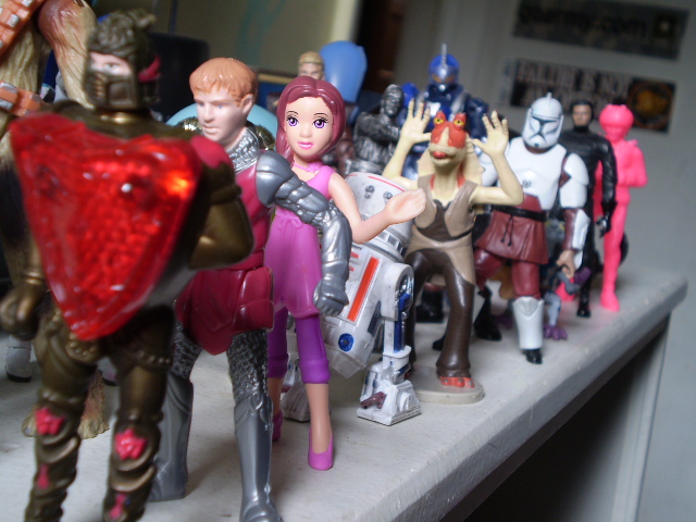 many toy action figures are arranged on a table