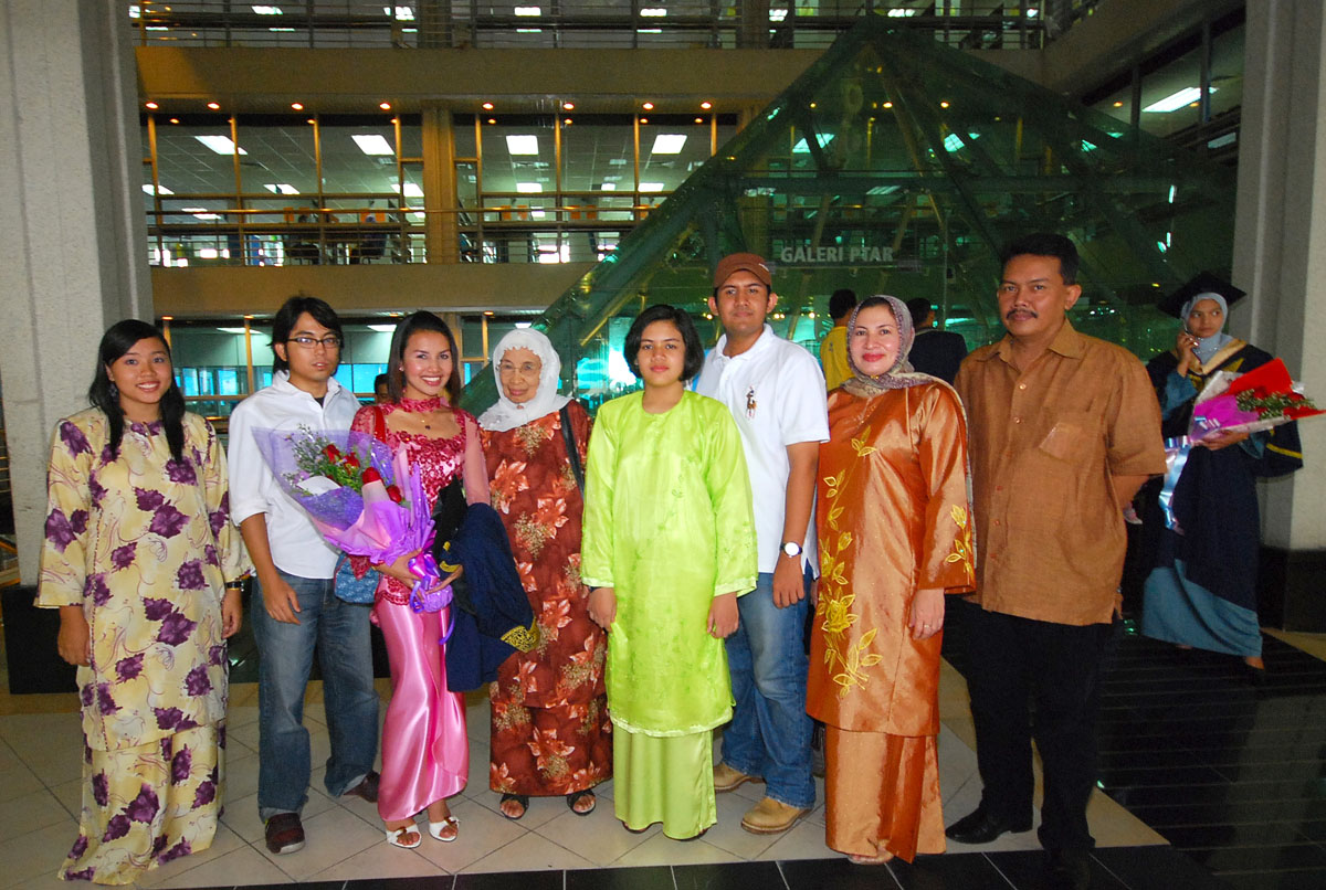 group of people dressed in oriental clothing posing for the camera