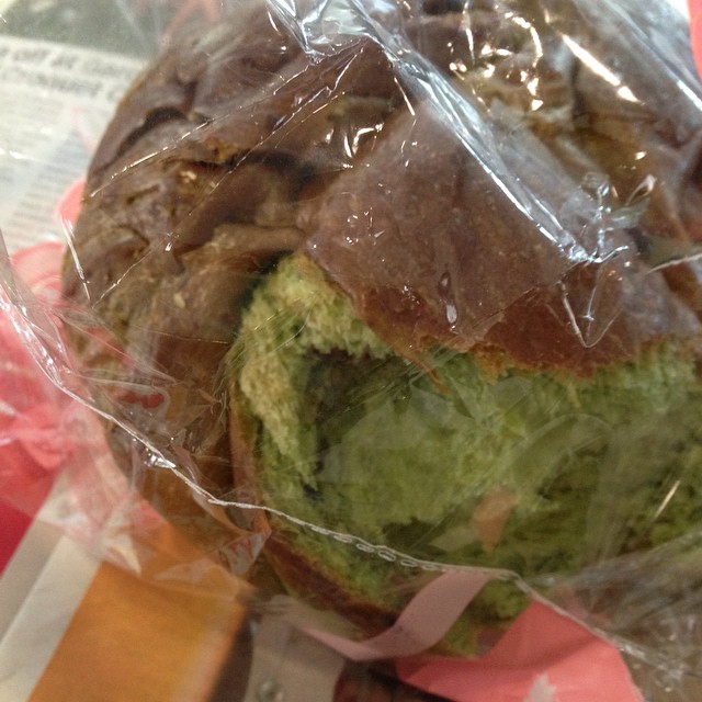 a sandwich wrapped in plastic with lettuce