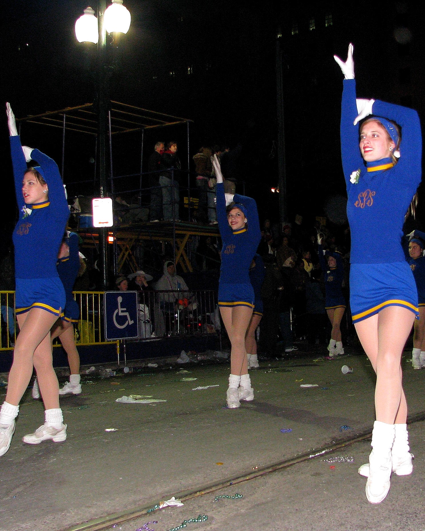 women performing in cheerleader outfits in front of a crowd