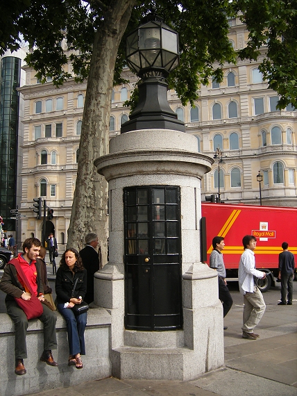 a bunch of people sitting next to a tower