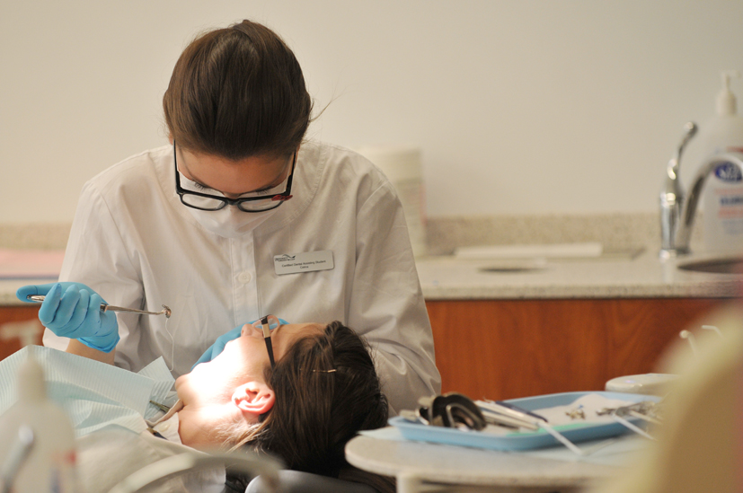 a dentist is performing  on a patient