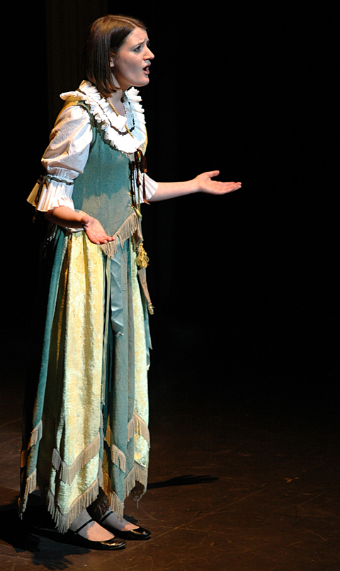 woman dressed in period clothes on stage for performance