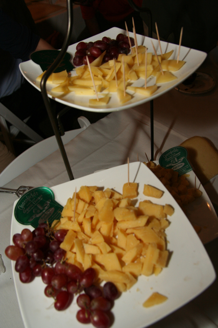 some cheeses are being served on small plates