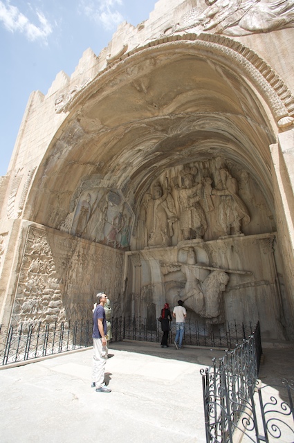 people standing at an archway of a monument