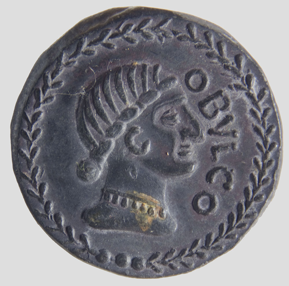 a ancient coin with a head on the reverse