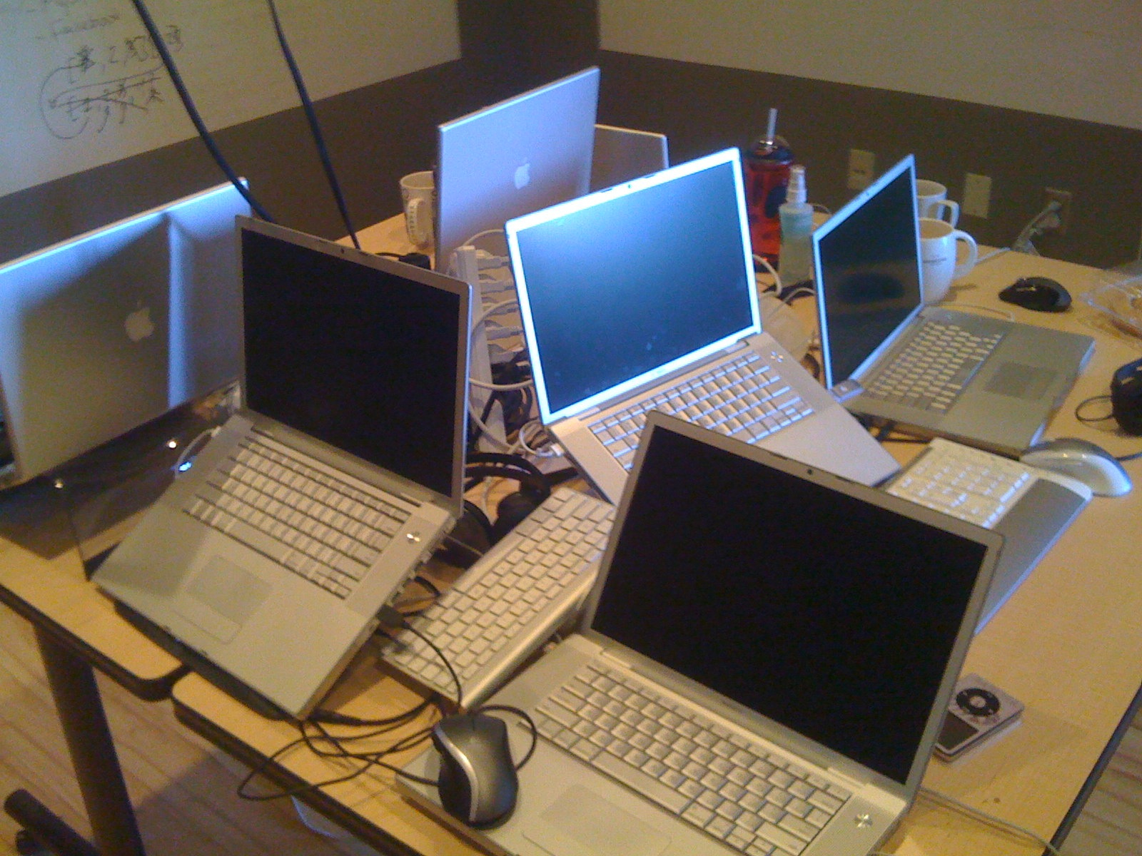 multiple laptops sit on top of a desk
