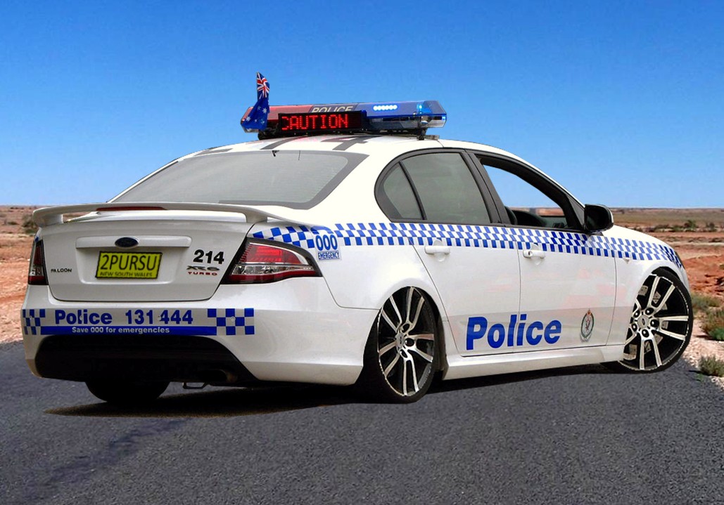 the police car is parked at the side of the road